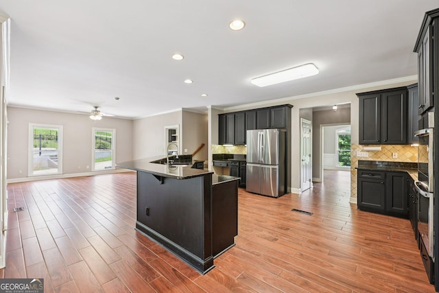 4685 Braselton Hwy, Hoschton, GA 30548 - kitchen featuring freestanding refrigerator, dark countertops, open floor plan, backsplash, and crown molding