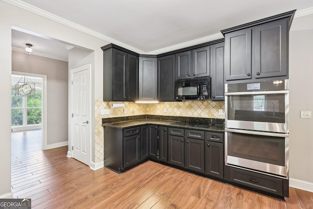 4685 Braselton Hwy, Hoschton, GA 30548 - kitchen featuring black appliances, tasteful backsplash, light wood-style floors, ornamental molding, and a chandelier