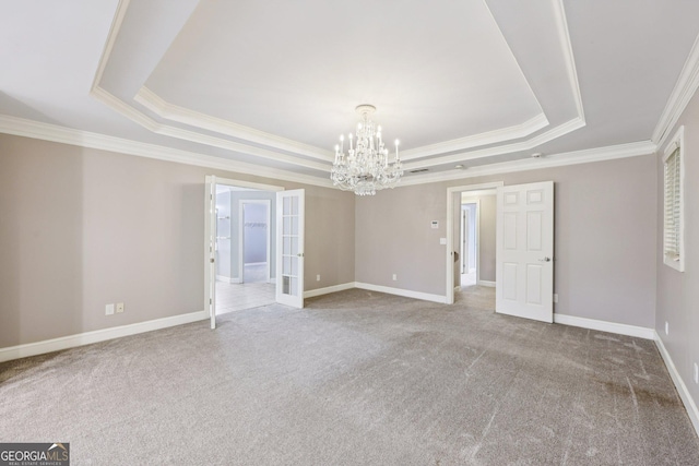 4685 Braselton Hwy, Hoschton, GA 30548 - empty room featuring a raised ceiling, ornamental molding, a chandelier, carpet floors, and french doors