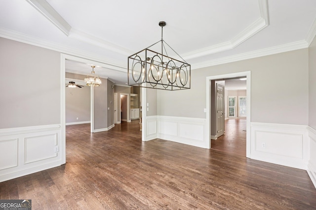 4685 Braselton Hwy, Hoschton, GA 30548 - unfurnished dining area with a chandelier, a raised ceiling, ornamental molding, dark wood-type flooring, and wainscoting