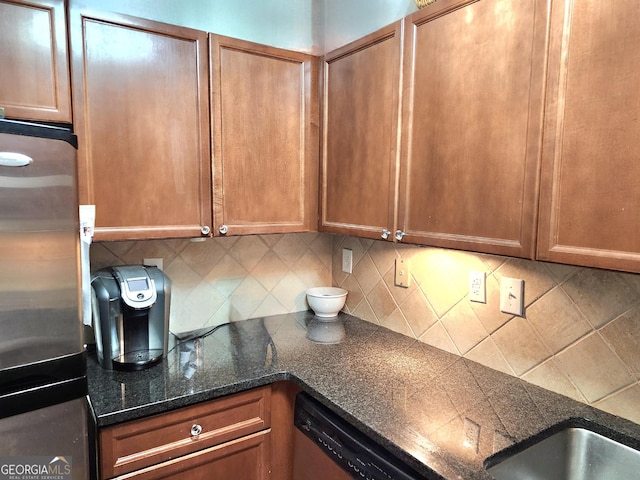 4250 River Green Dr NW Apt 405, Atlanta, GA 30327 - kitchen featuring appliances with stainless steel finishes, decorative backsplash, and brown cabinetry