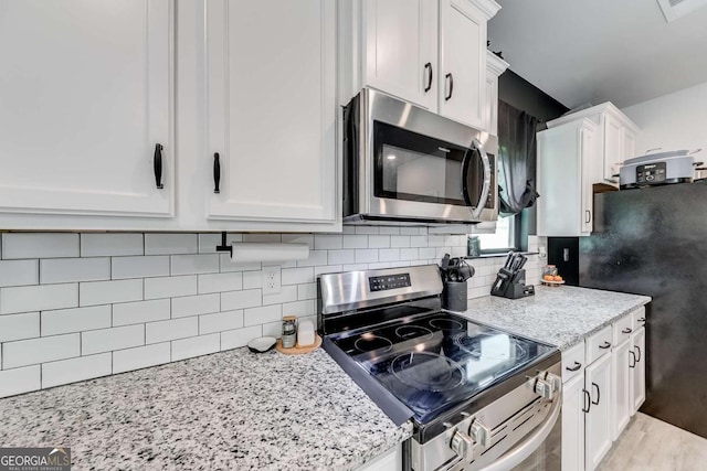 191 Eagle Heights Dr, Maysville, GA 30558 - kitchen with appliances with stainless steel finishes, white cabinetry, backsplash, and light stone countertops