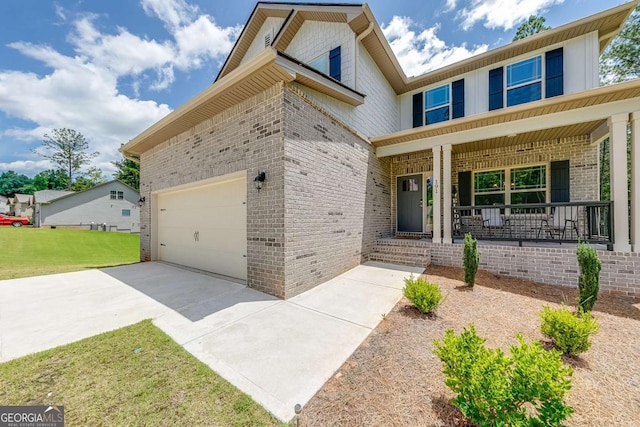 191 Eagle Heights Dr, Maysville, GA 30558 - view of front of property with brick siding, covered porch, driveway, a front lawn, and an attached garage
