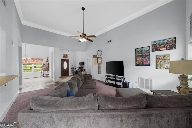79 Hampton Hills Ln, Cleveland, GA 30528 - carpeted living area with a chandelier, crown molding, a towering ceiling, a ceiling fan, and decorative columns