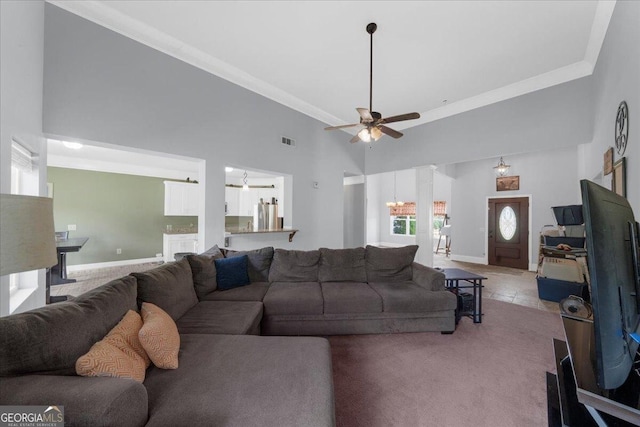 79 Hampton Hills Ln, Cleveland, GA 30528 - living room with a ceiling fan, a towering ceiling, light colored carpet, and ornamental molding