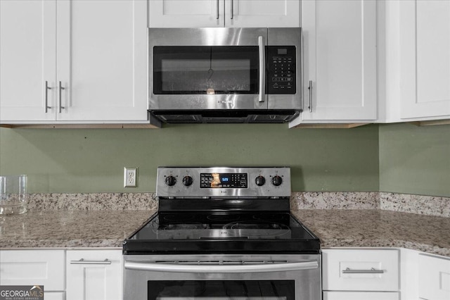 79 Hampton Hills Ln, Cleveland, GA 30528 - kitchen with appliances with stainless steel finishes, white cabinets, and light stone countertops