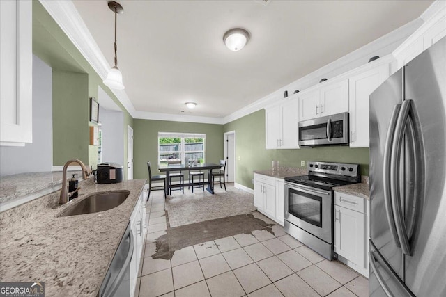 79 Hampton Hills Ln, Cleveland, GA 30528 - kitchen with appliances with stainless steel finishes, ornamental molding, white cabinets, light tile patterned floors, and light stone counters
