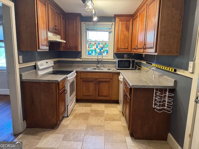 520 Holman Ave, Athens, GA 30606 - kitchen featuring appliances with stainless steel finishes, under cabinet range hood, and brown cabinets