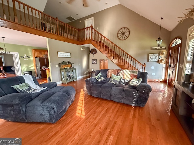 1940 Horne Rd, Eastman, GA 31023 - living room with high vaulted ceiling, stairs, and light wood-style floors