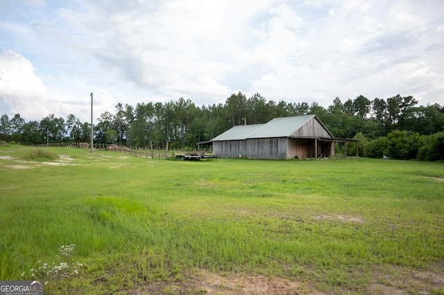 1940 Horne Rd, Eastman, GA 31023 - view of green lawn featuring a pole building, an outbuilding, a carport, and a view of countryside