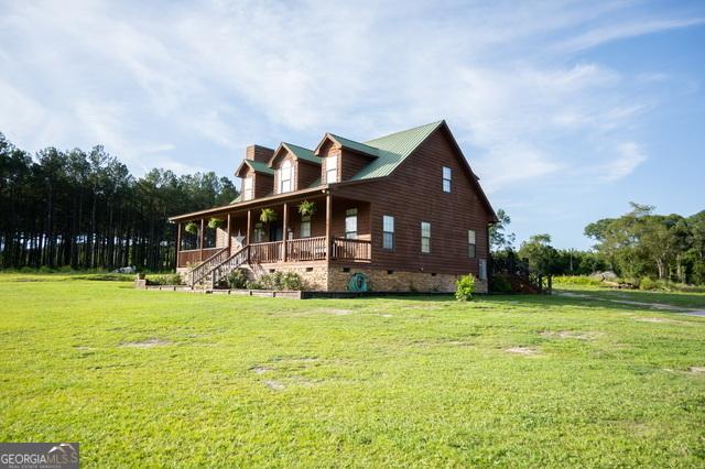 1940 Horne Rd, Eastman, GA 31023 - view of side of home featuring a porch, crawl space, a yard, and a chimney