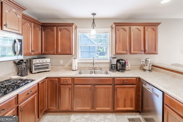 53 Denny Ln, Dallas, GA 30157 - kitchen with stainless steel appliances, light countertops, and decorative light fixtures