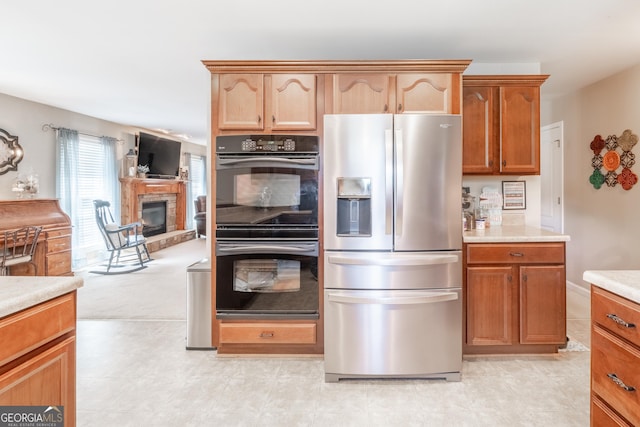 53 Denny Ln, Dallas, GA 30157 - kitchen featuring stainless steel refrigerator with ice dispenser, light countertops, and a glass covered fireplace