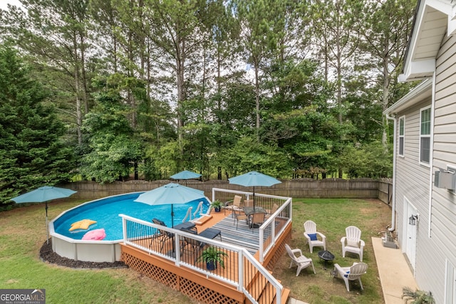 53 Denny Ln, Dallas, GA 30157 - view of pool featuring outdoor dining area, a wooden deck, a fenced backyard, and view of scattered trees