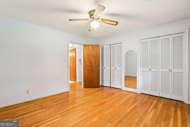 415 Haven Ln, Marietta, GA 30066 - unfurnished bedroom with multiple closets, light wood-style flooring, and ceiling fan