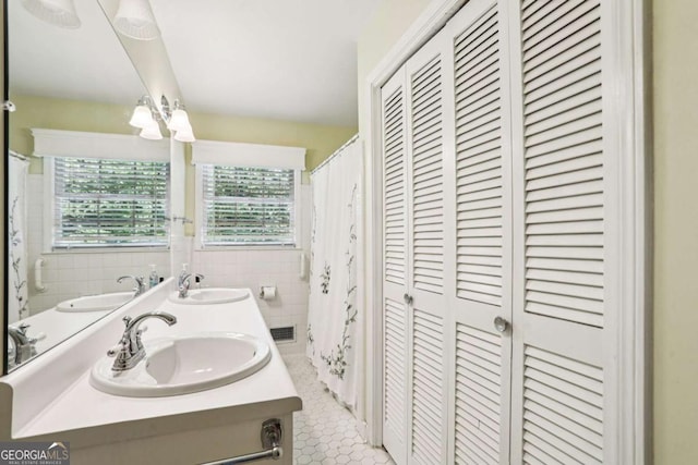 415 Haven Ln, Marietta, GA 30066 - full bathroom featuring a closet, tile walls, double vanity, and tile patterned flooring