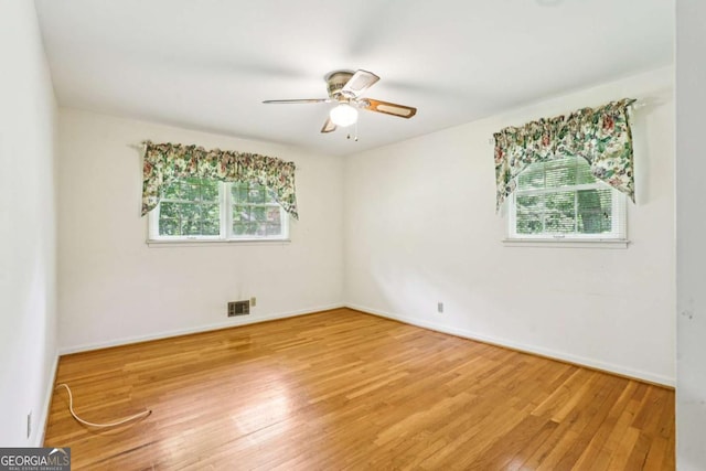 415 Haven Ln, Marietta, GA 30066 - empty room featuring healthy amount of natural light, a ceiling fan, and light wood-type flooring