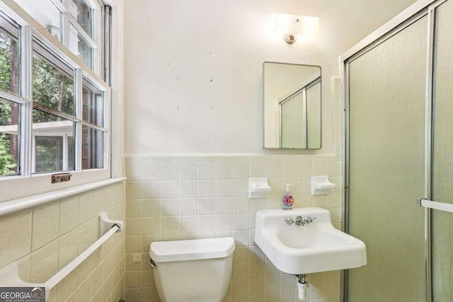 415 Haven Ln, Marietta, GA 30066 - full bathroom featuring tile walls, a wainscoted wall, and a stall shower
