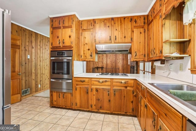 415 Haven Ln, Marietta, GA 30066 - kitchen with stainless steel oven, a warming drawer, gas cooktop, wood walls, and light countertops