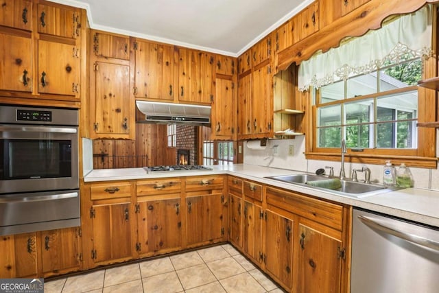 415 Haven Ln, Marietta, GA 30066 - kitchen featuring stainless steel appliances, a warming drawer, under cabinet range hood, light countertops, and brown cabinets