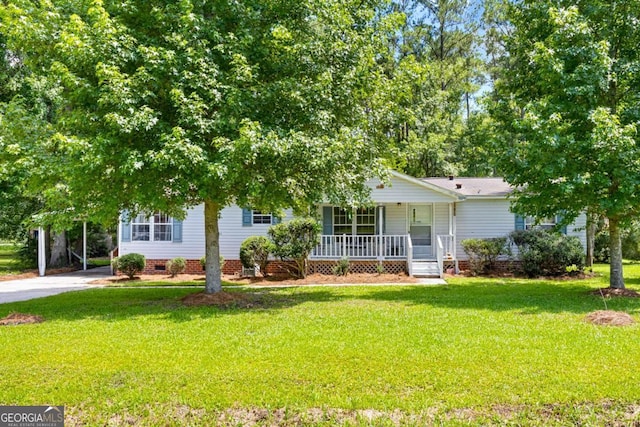 203 Shaw St, Rincon, GA 31326 - view of front facade with a porch, a front lawn, concrete driveway, crawl space, and a carport