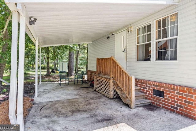 203 Shaw St, Rincon, GA 31326 - view of patio with a storage unit and an attached carport