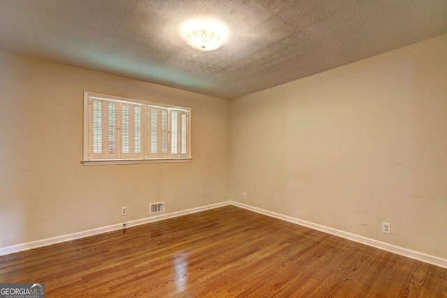 5739 Cobb Mdw, Norcross, GA 30093 - unfurnished room featuring wood finished floors and a textured ceiling