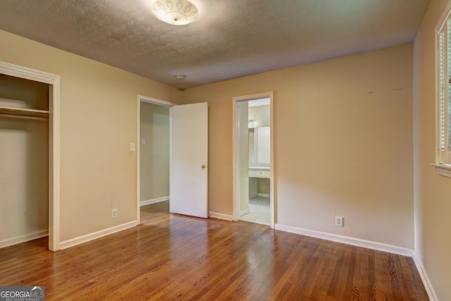 5739 Cobb Mdw, Norcross, GA 30093 - unfurnished bedroom with wood finished floors, a closet, and ensuite bathroom