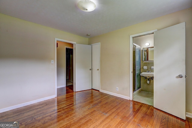 5739 Cobb Mdw, Norcross, GA 30093 - unfurnished bedroom featuring wood finished floors and connected bathroom