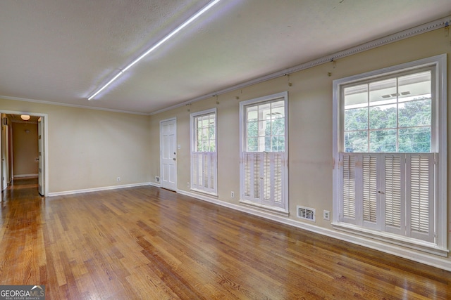 5739 Cobb Mdw, Norcross, GA 30093 - spare room with wood finished floors and crown molding