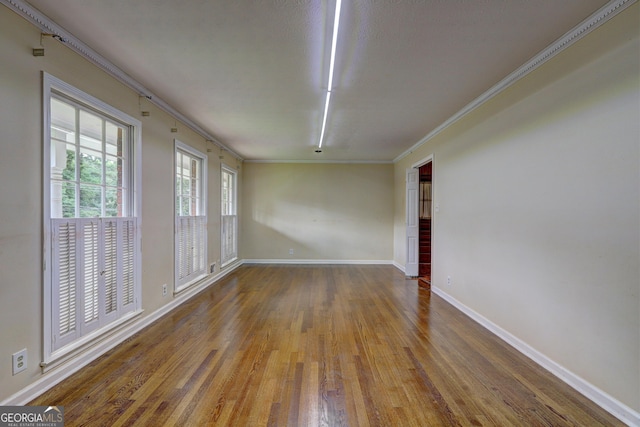 5739 Cobb Mdw, Norcross, GA 30093 - spare room with wood finished floors and ornamental molding