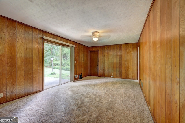 5739 Cobb Mdw, Norcross, GA 30093 - spare room featuring wooden walls, carpet, a textured ceiling, and a ceiling fan