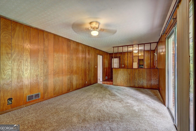 5739 Cobb Mdw, Norcross, GA 30093 - unfurnished living room with carpet, ceiling fan, and wooden walls