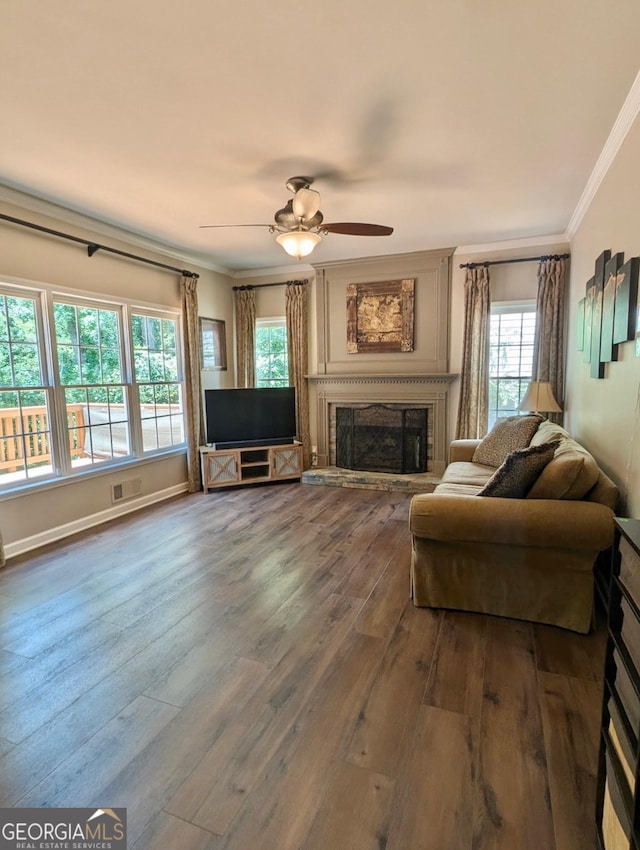 1581 Shetland Pony Ct NW, Suwanee, GA 30024 - living area featuring ornamental molding, hardwood / wood-style floors, a ceiling fan, and a fireplace with raised hearth