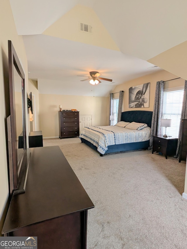 1581 Shetland Pony Ct NW, Suwanee, GA 30024 - carpeted bedroom featuring multiple windows, vaulted ceiling, and a ceiling fan