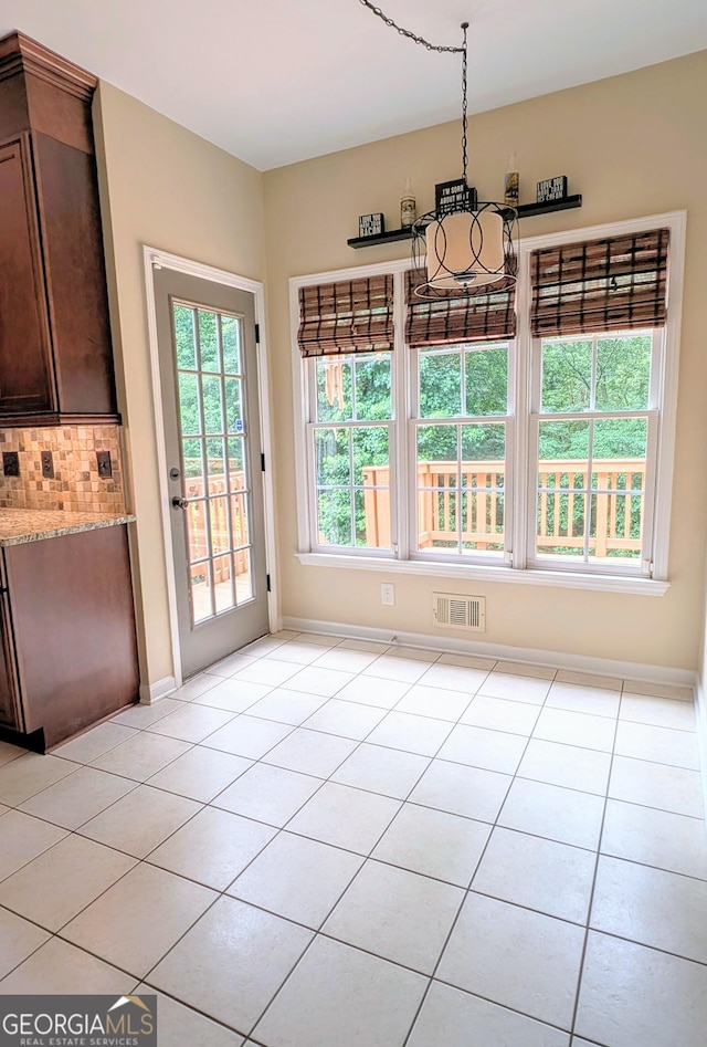 1581 Shetland Pony Ct NW, Suwanee, GA 30024 - unfurnished dining area featuring light tile patterned floors