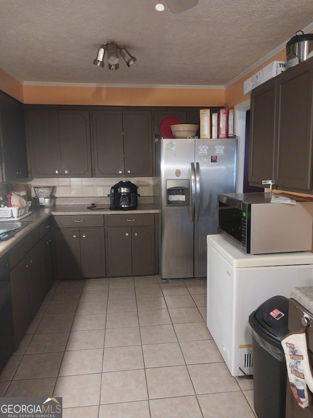 1008 E 12th St, West Point, GA 31833 - kitchen featuring appliances with stainless steel finishes, a textured ceiling, light tile patterned floors, ornamental molding, and light countertops