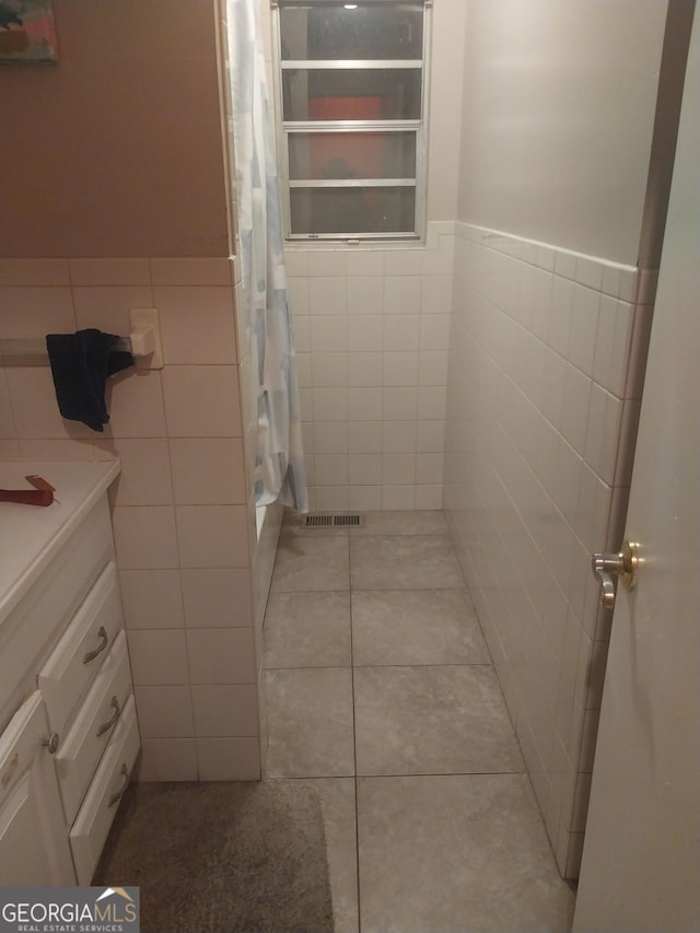 1008 E 12th St, West Point, GA 31833 - full bathroom featuring tile walls, radiator heating unit, tile patterned floors, a shower with curtain, and vanity