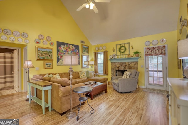 1248 Rockview Ct, Loganville, GA 30052 - living area featuring high vaulted ceiling, ceiling fan, light wood-type flooring, and a stone fireplace