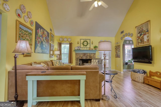 1248 Rockview Ct, Loganville, GA 30052 - living room with high vaulted ceiling, a ceiling fan, wood finished floors, and a fireplace