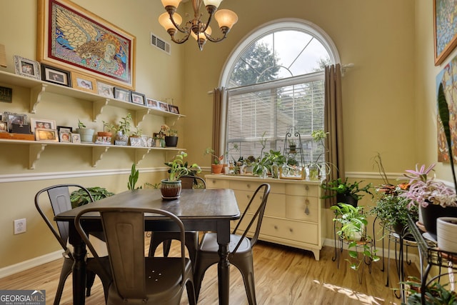 1248 Rockview Ct, Loganville, GA 30052 - dining room with a chandelier and light wood-style flooring
