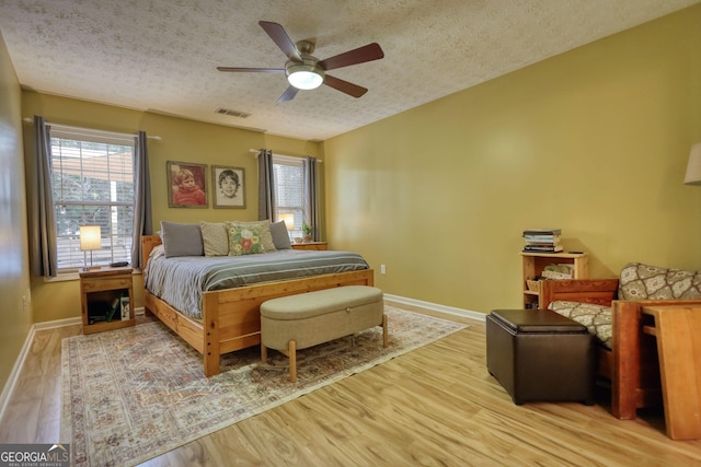 1248 Rockview Ct, Loganville, GA 30052 - bedroom with a textured ceiling, wood finished floors, and ceiling fan