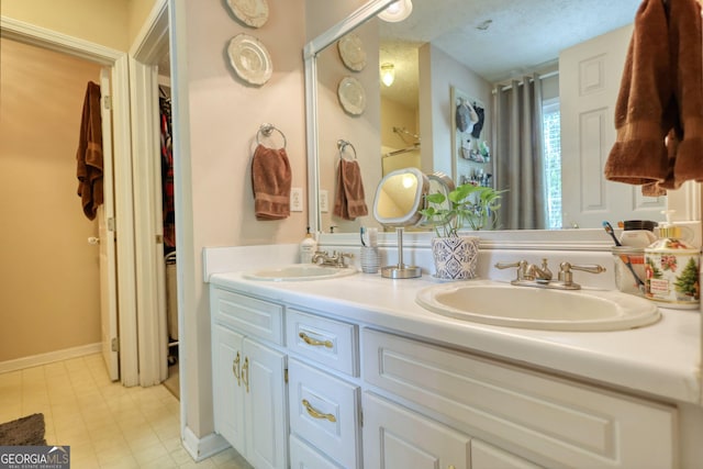 1248 Rockview Ct, Loganville, GA 30052 - bathroom featuring double vanity, a spacious closet, and a shower