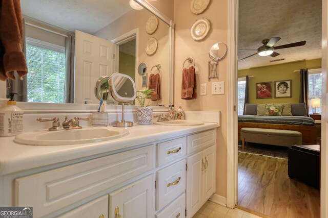 1248 Rockview Ct, Loganville, GA 30052 - ensuite bathroom with double vanity, plenty of natural light, ceiling fan, and tile patterned floors