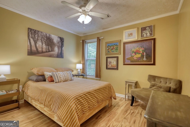 1248 Rockview Ct, Loganville, GA 30052 - bedroom with wood finished floors, a textured ceiling, ornamental molding, and a ceiling fan