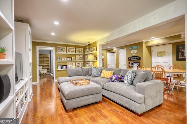 1248 Rockview Ct, Loganville, GA 30052 - living room featuring ornamental molding, recessed lighting, light wood-style flooring, and built in features