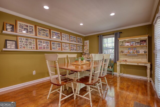 1248 Rockview Ct, Loganville, GA 30052 - dining room featuring wood finished floors, crown molding, and recessed lighting