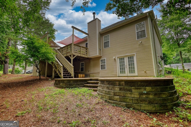 1248 Rockview Ct, Loganville, GA 30052 - back of property with french doors, a deck, a chimney, and stairway