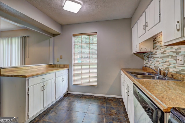 5026 Brittany Dr, Stone Mountain, GA 30083 - kitchen with stainless steel dishwasher, decorative backsplash, white cabinetry, a textured ceiling, and range with electric stovetop