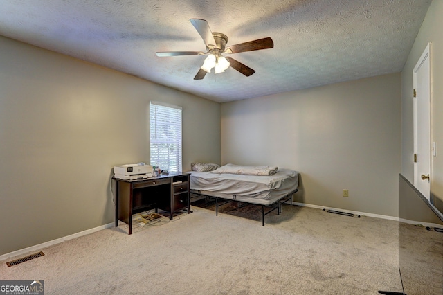 5026 Brittany Dr, Stone Mountain, GA 30083 - carpeted bedroom with a textured ceiling and a ceiling fan